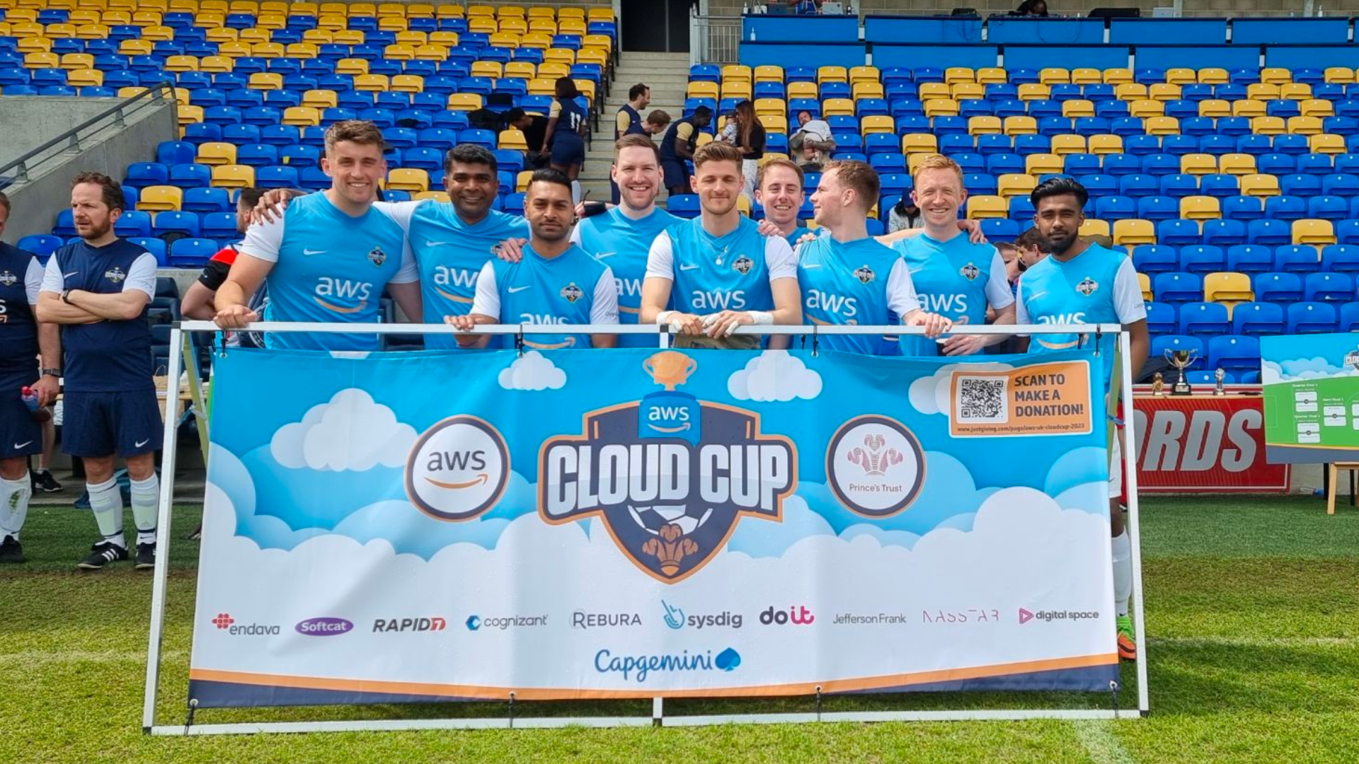 Cloud Cup charity football team photo on field inside stadium.